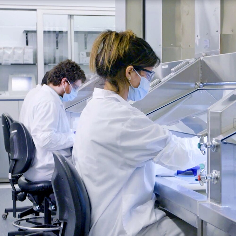Biochemists using microscope while working on scientific research in a laboratory.