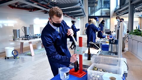 A participant learns the impact of manual processes on production
