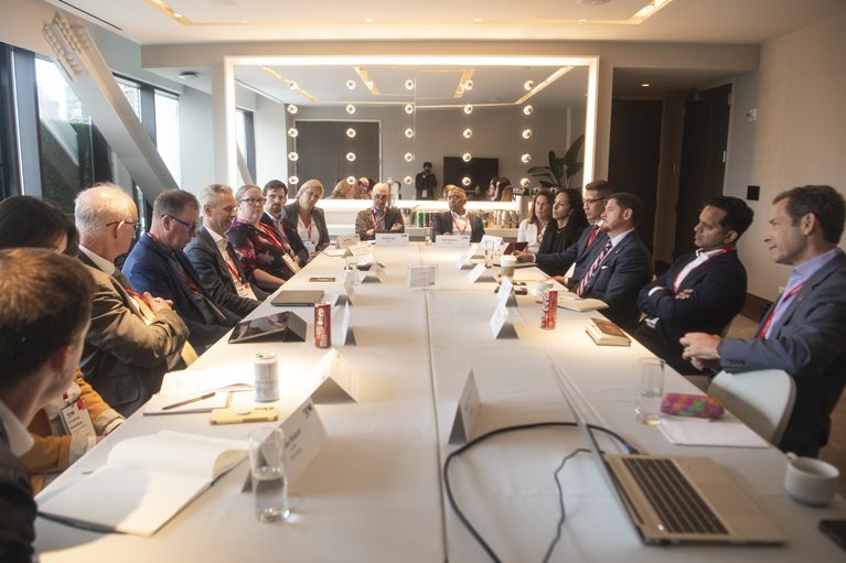 Attendees of Climate Week NYC sitting around a table in discussion