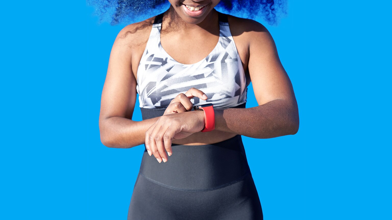 Close up of a woman tapping her finger against her smart watch.